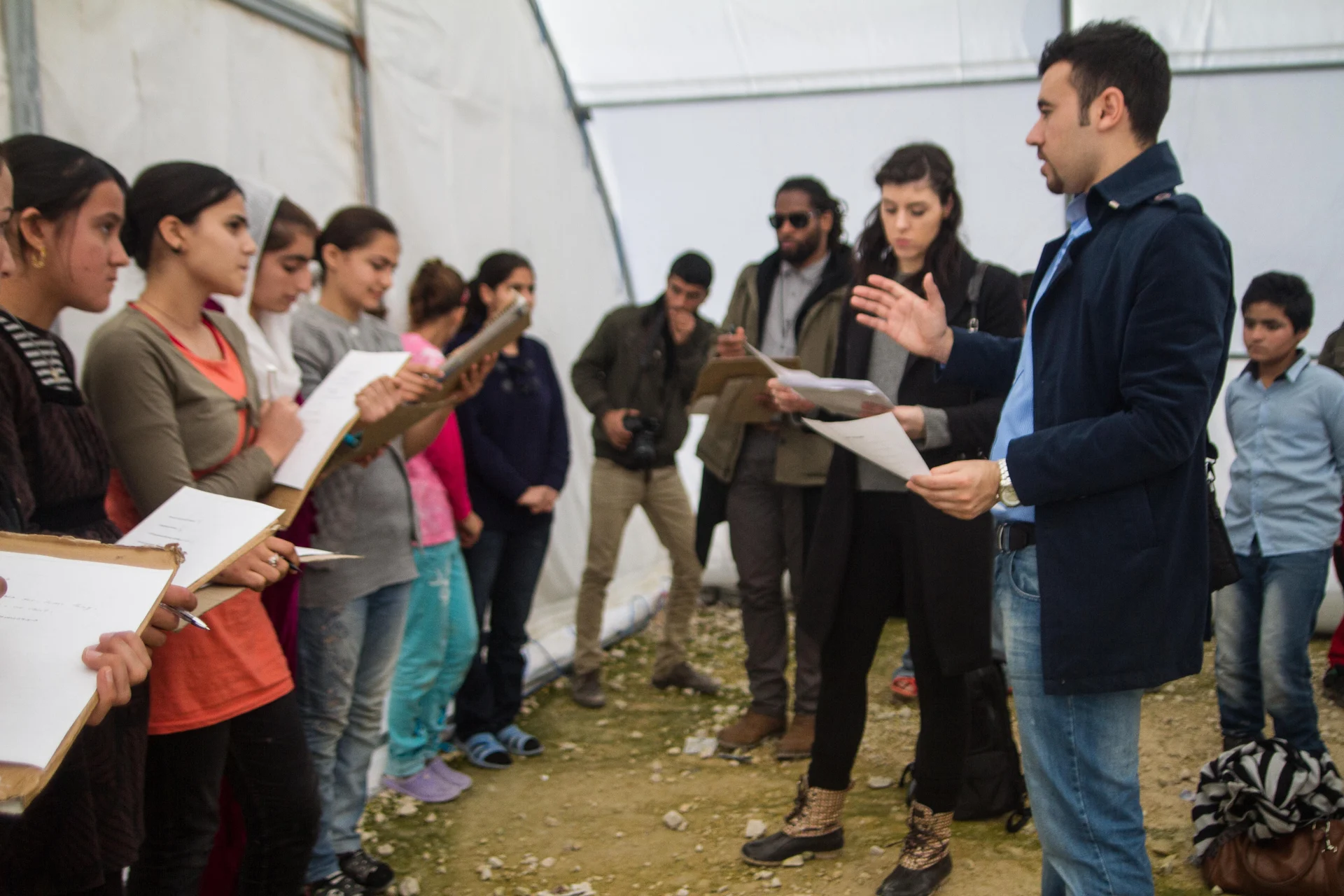 A WE workshop facilitator and young participants share ideas inside a learning space in Iraq.